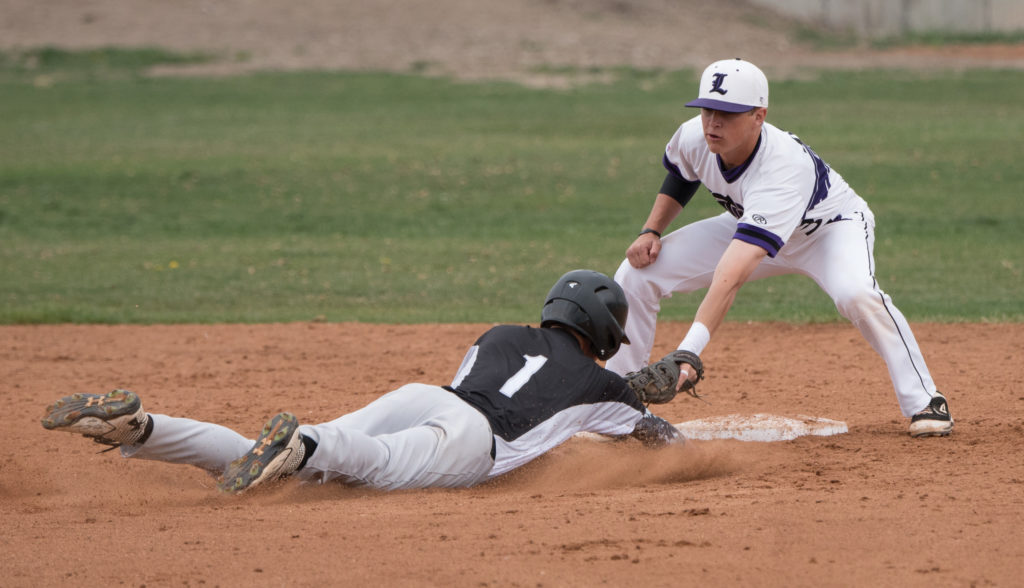 Lehi’s Tyler Willis tags a runner at second base. Photo credit: Josh Hansen