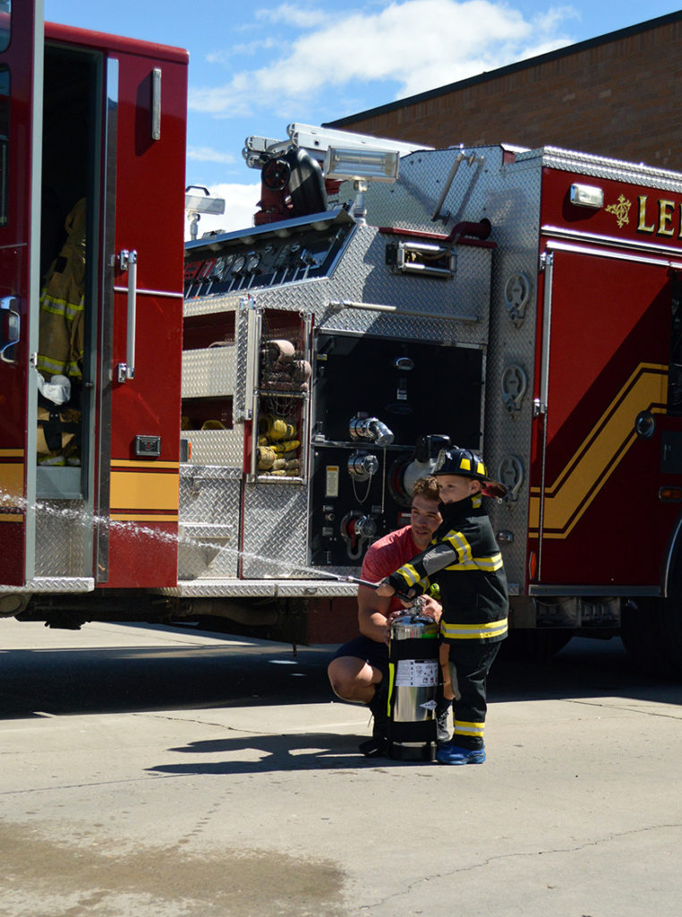 Lehi firefighter training a new recruit. Photo: Nicole Kunze