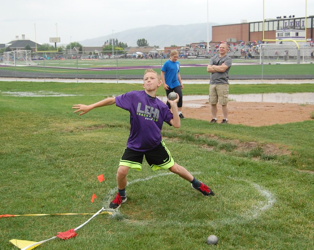 11-year-old Kyler Young throws the shotput. In his first year, Kyler advanced from a starting 17-feet throw to a 25-feet personal best. Photo: Cavett Ishihara