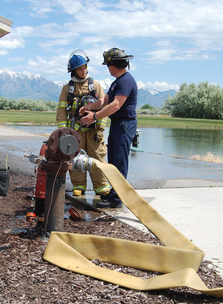 10-year Lehi Firefighter Tee Hover (right) reviews the results and details of the training scenario with Intern Zac Lucero. Photo: Cavett Ishihara