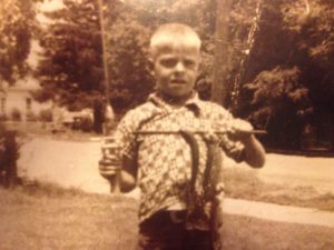 Bill Fowler, 8, holds his catch triumphantly.