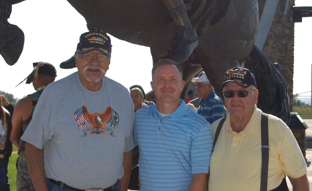 Jerime Hooley (center) presents his 13-foot bronze statue “Ute Warrior Chief” with Ute Tribal Elders Bob Chapoose (left) and Dolan Sorenson (right) at the unveiling ceremony held July 2, 2016 at the Fort Duchesne Ute Indian Tribe Veteran Memorial Park. Photo courtesy of MaKay Hooley