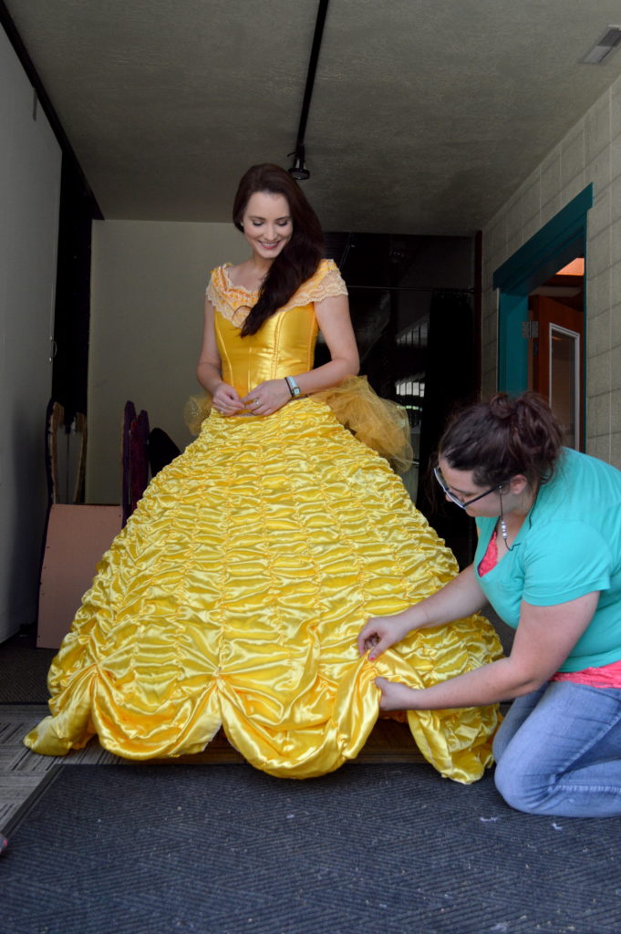 Erica Glenn getting a final fitting for Belle’s ball gown with  Mariah Knittle. Photo: Nicole Kunze